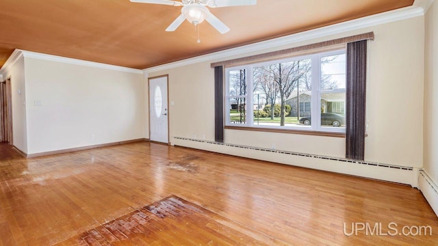 606 S 13th St, Gladstone, MI 49837 - empty room featuring crown molding, baseboard heating, hardwood / wood-style floors, and a ceiling fan