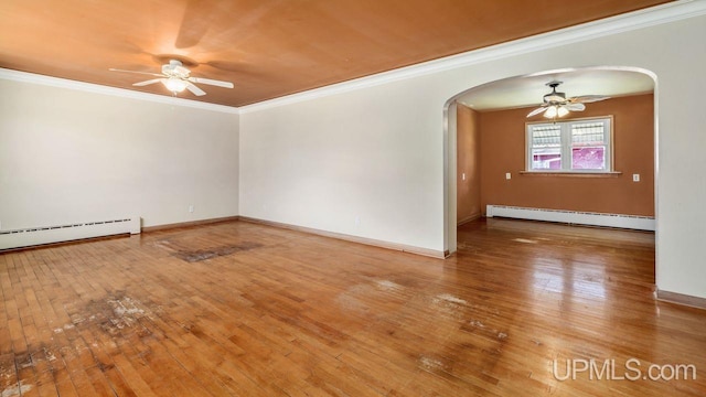 606 S 13th St, Gladstone, MI 49837 - unfurnished room with a baseboard radiator, arched walkways, ceiling fan, ornamental molding, and hardwood / wood-style flooring