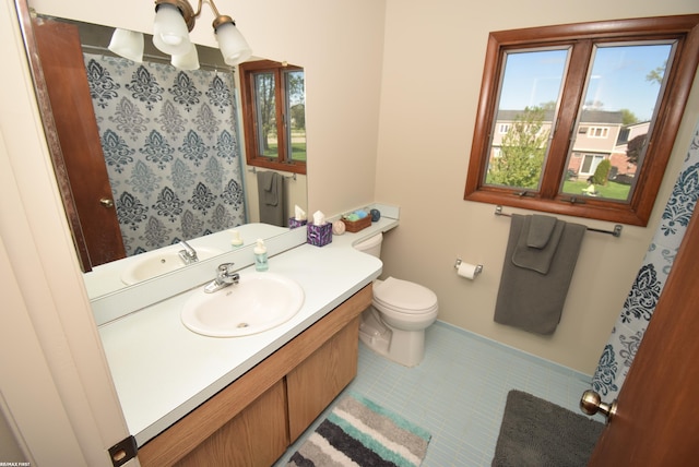 full bath with toilet, baseboards, vanity, tile patterned flooring, and a chandelier