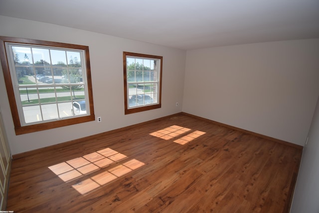 unfurnished room featuring wood finished floors and baseboards