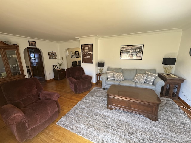 104 Memory Lane Dr, Crystal Falls, MI 49920 - living area with arched walkways, wood finished floors, crown molding, and baseboards