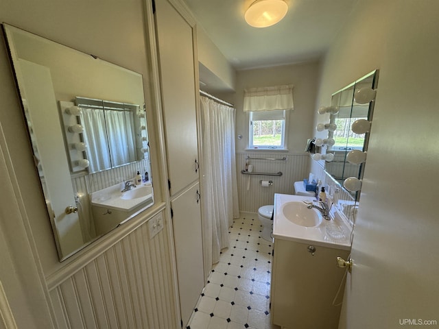 1100 Poplar Ave, Crystal Falls, MI 49920 - full bathroom with tile patterned floors, vanity, toilet, and a shower with shower curtain