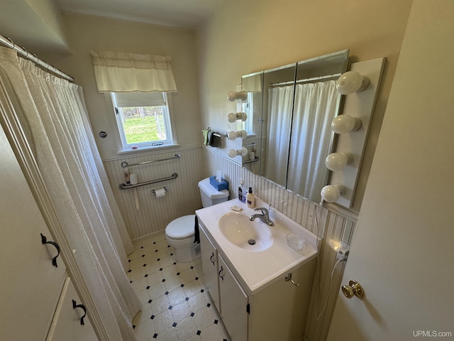 1100 Poplar Ave, Crystal Falls, MI 49920 - full bath with a wainscoted wall, toilet, vanity, tile patterned floors, and a shower with shower curtain