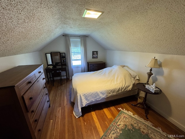 1100 Poplar Ave, Crystal Falls, MI 49920 - bedroom with wood finished floors, a textured ceiling, lofted ceiling, and baseboards