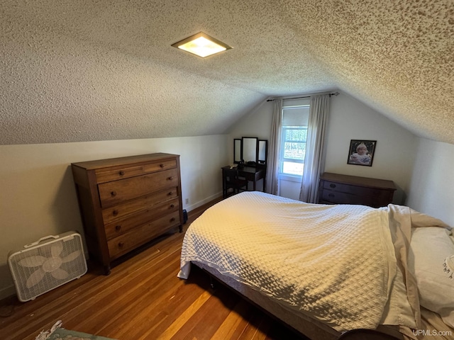 1100 Poplar Ave, Crystal Falls, MI 49920 - bedroom featuring wood finished floors, a textured ceiling, vaulted ceiling, and baseboards