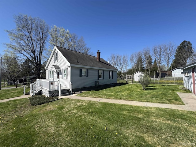 1100 Poplar Ave, Crystal Falls, MI 49920 - view of property exterior featuring a chimney, a yard, and a shingled roof