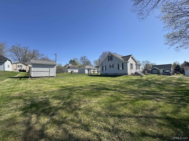 1100 Poplar Ave, Crystal Falls, MI 49920 - view of grassy yard with an outbuilding and a storage shed