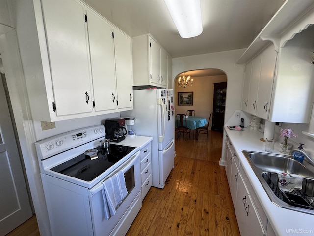 1100 Poplar Ave, Crystal Falls, MI 49920 - kitchen with white appliances, hardwood / wood-style flooring, a sink, a chandelier, and arched walkways