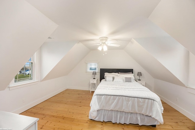 bedroom featuring ceiling fan, vaulted ceiling, light wood-style flooring, and baseboards