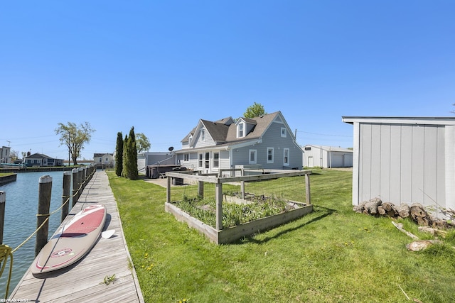 dock area with a lawn and a water view