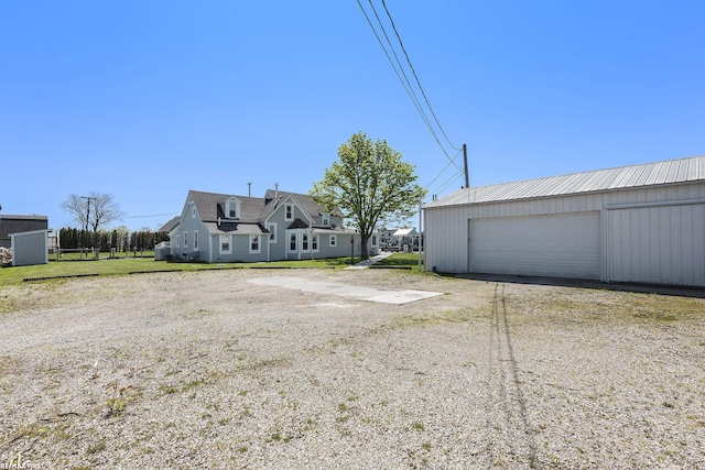 view of yard with an outbuilding and a detached garage