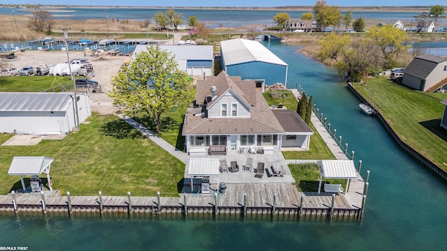 aerial view of property and surrounding area with a nearby body of water