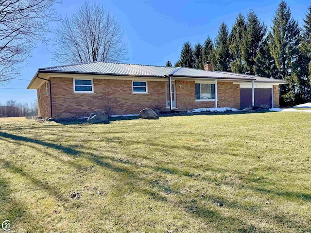 15250 34 Mile Rd, Armada, MI 48005 - view of front of property featuring brick siding, an attached garage, a chimney, a front yard, and metal roof