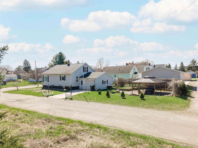 739 N 6th Ave, Iron River, MI 49935 - bungalow-style home with a gazebo, driveway, a front yard, and an attached garage