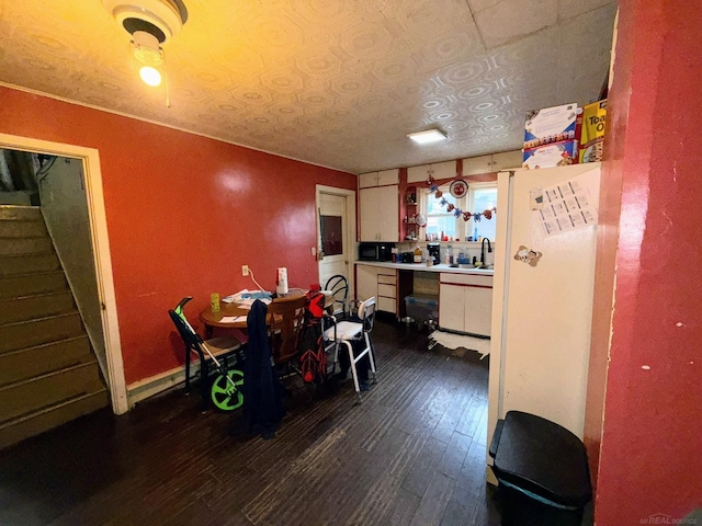 306 N Ionia St, Gladwin, MI 48624 - dining room featuring dark wood finished floors and stairway