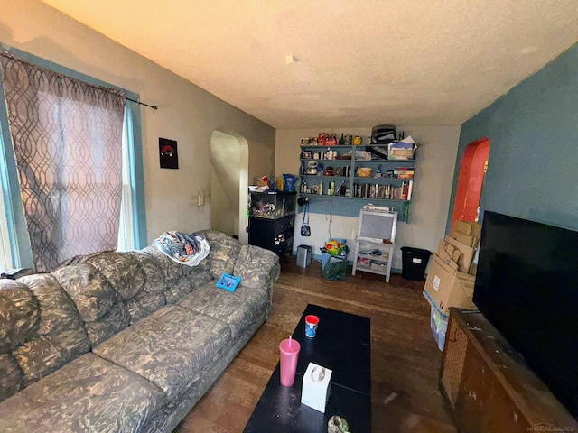 306 N Ionia St, Gladwin, MI 48624 - living area with arched walkways and wood finished floors