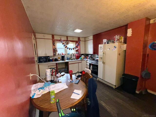 306 N Ionia St, Gladwin, MI 48624 - kitchen featuring white fridge with ice dispenser, stainless steel electric range, black microwave, a sink, and light countertops