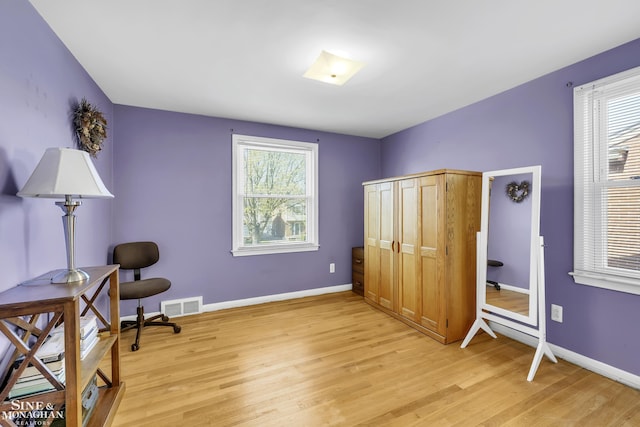 sitting room featuring light wood-style flooring and baseboards