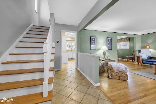 stairs with tile patterned floors and baseboards