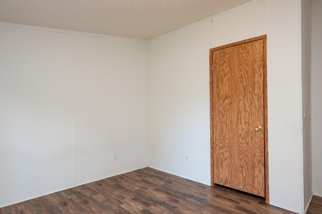 1448 W Sian Dr, Sanford, MI 48657 - unfurnished room with dark wood-style floors