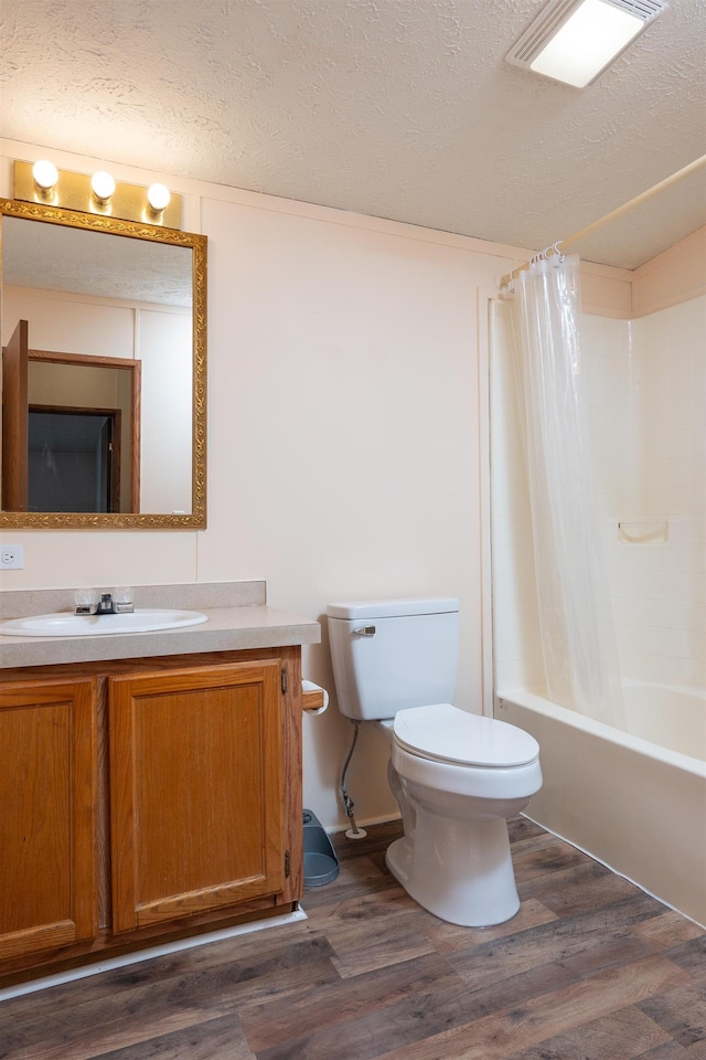 1448 W Sian Dr, Sanford, MI 48657 - full bath with toilet, wood finished floors, a textured ceiling, vanity, and shower / bath combination with curtain