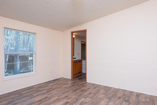 1448 W Sian Dr, Sanford, MI 48657 - empty room featuring dark wood-style flooring and a textured ceiling
