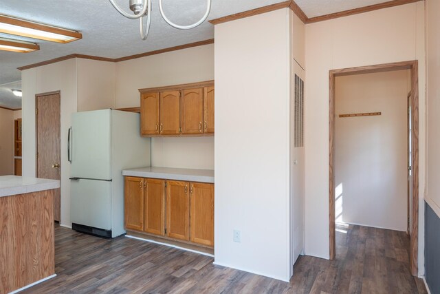 1448 W Sian Dr, Sanford, MI 48657 - kitchen featuring freestanding refrigerator, light countertops, dark wood-style flooring, crown molding, and brown cabinetry