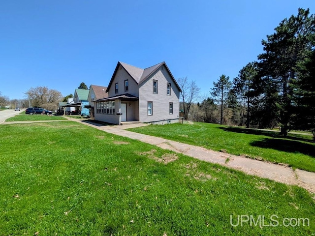 737 Forest Ave, Crystal Falls, MI 49920 - view of side of home with a lawn