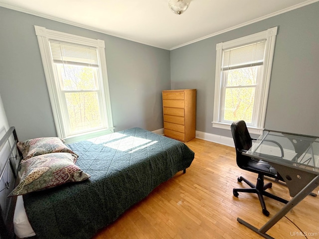 bedroom with crown molding, wood-type flooring, baseboards, and an office area
