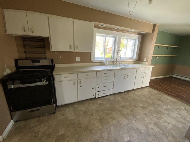 6053 Van Dyke Rd, Brown City, MI 48416 - kitchen with stainless steel range with gas stovetop, a sink, light countertops, and white cabinetry
