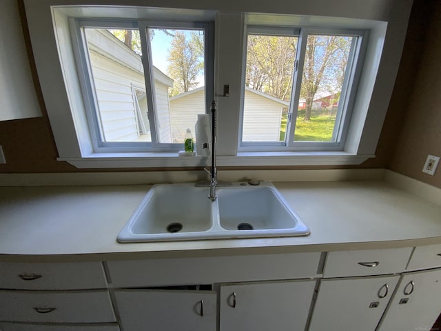 6053 Van Dyke Rd, Brown City, MI 48416 - kitchen view of a sink, white cabinetry, and light countertops