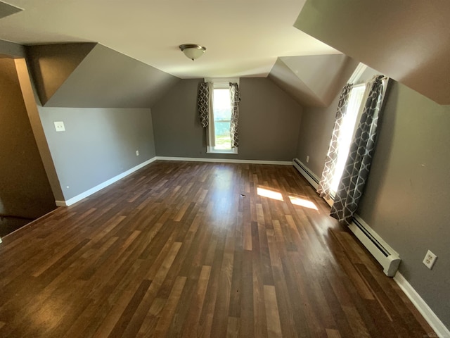 6053 Van Dyke Rd, Brown City, MI 48416 - additional living space with a baseboard radiator, dark wood-type flooring, baseboards, and vaulted ceiling
