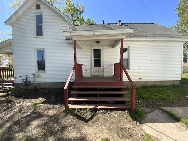 6053 Van Dyke Rd, Brown City, MI 48416 - rear view of house with a shingled roof and fence