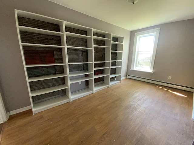 6053 Van Dyke Rd, Brown City, MI 48416 - spare room featuring wood finished floors, baseboards, and a baseboard radiator