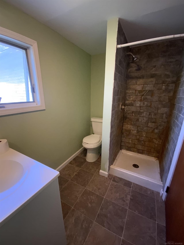 6053 Van Dyke Rd, Brown City, MI 48416 - full bath with toilet, tiled shower, tile patterned floors, baseboards, and vanity