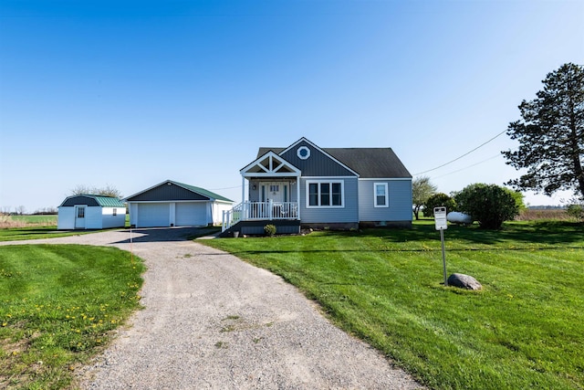410 E Nicol Rd, Sandusky, MI 48471 - view of front facade featuring an outbuilding, a detached garage, and a front lawn