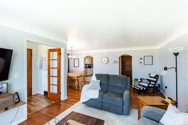 410 E Nicol Rd, Sandusky, MI 48471 - living room with arched walkways, a chandelier, wood finished floors, and baseboards