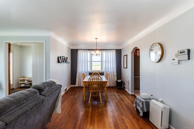 410 E Nicol Rd, Sandusky, MI 48471 - dining space with arched walkways, dark wood finished floors, a chandelier, and baseboards