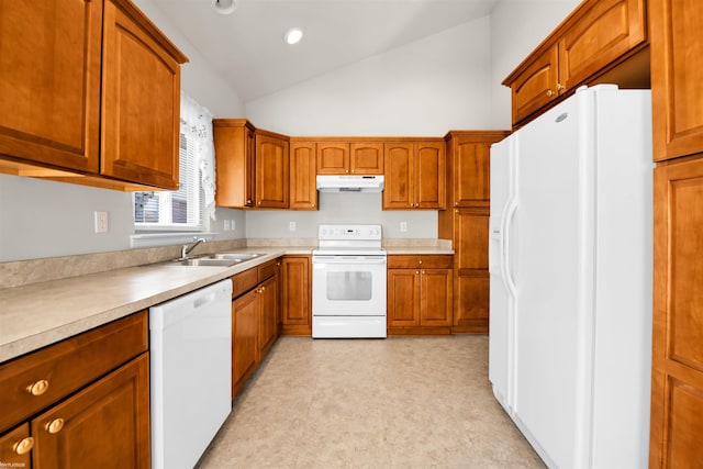 kitchen featuring white appliances, a sink, vaulted ceiling, under cabinet range hood, and brown cabinetry