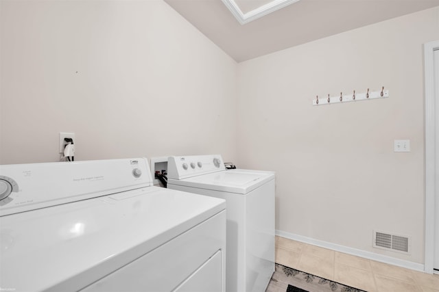 laundry area with washer and dryer and baseboards
