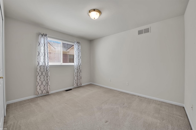 unfurnished room with carpet floors and baseboards