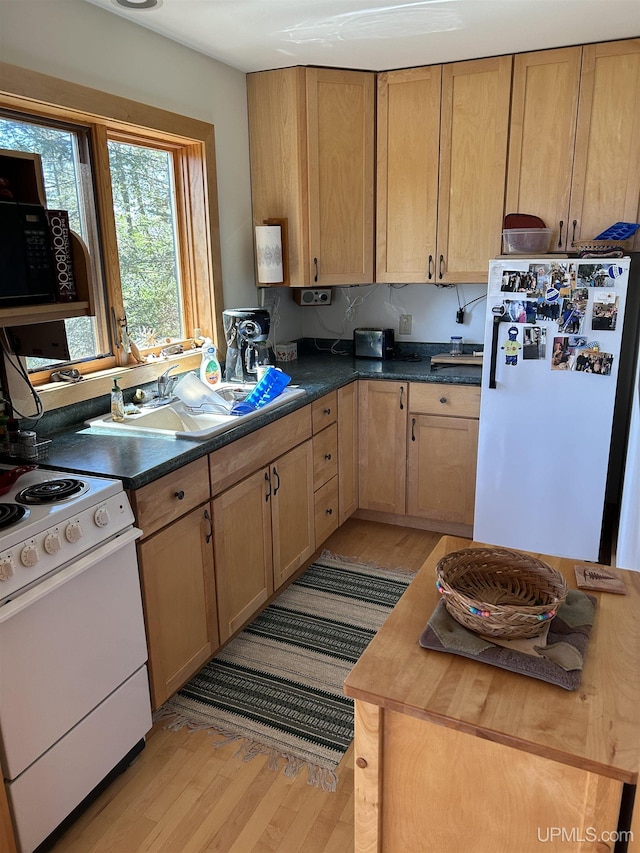 25393 Campsite Dr, Michigamme, MI 49861 - kitchen with white appliances, light wood-type flooring, and dark countertops