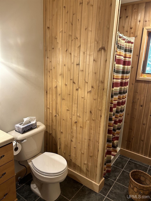 25393 Campsite Dr, Michigamme, MI 49861 - bathroom with tile patterned floors, toilet, curtained shower, and vanity