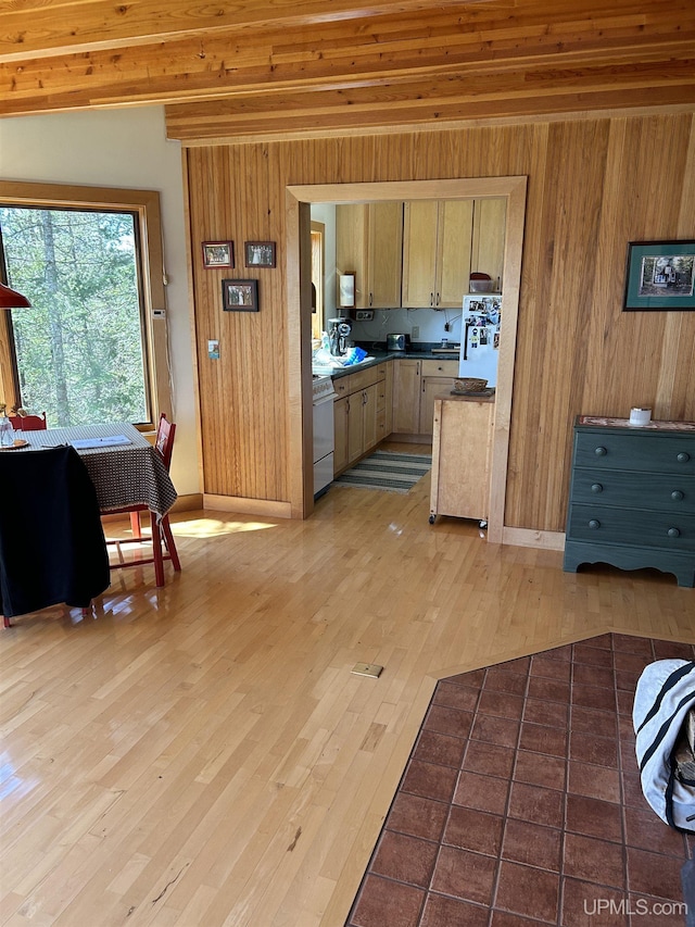 25393 Campsite Dr, Michigamme, MI 49861 - kitchen with wooden walls, light wood-style floors, dark countertops, white gas range oven, and baseboards