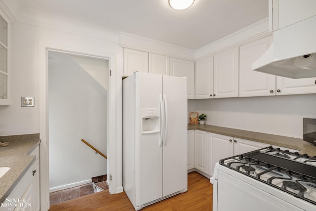 kitchen featuring white appliances, white cabinetry, under cabinet range hood, and light wood-style floors