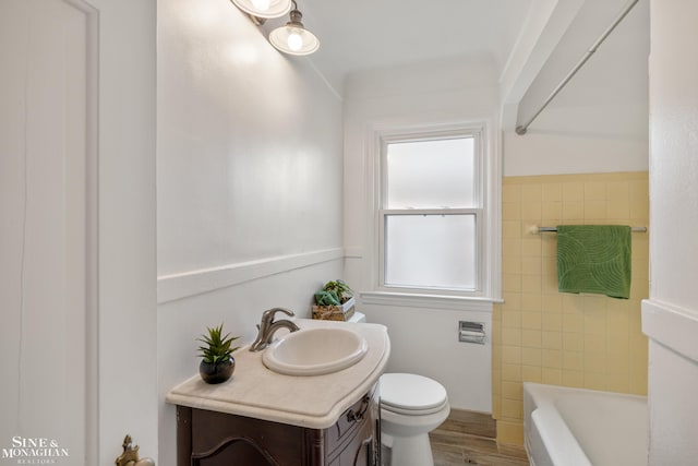 bathroom featuring toilet, a bathtub, wood finished floors, vanity, and a shower