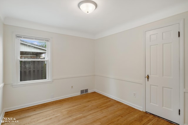 spare room with light wood-style flooring and baseboards
