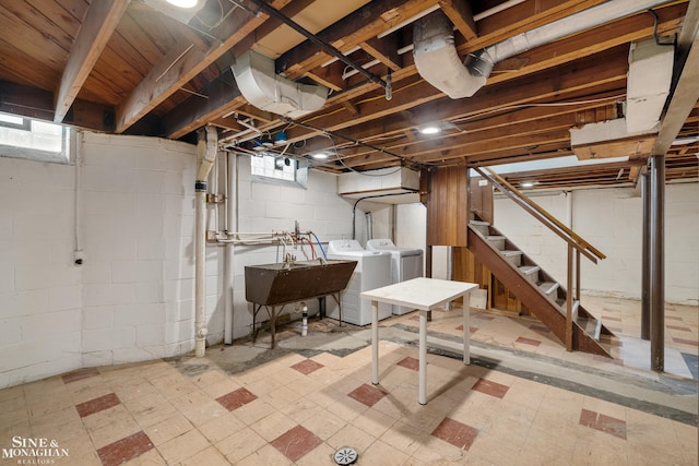 basement with washer and clothes dryer, tile patterned floors, stairs, and a sink