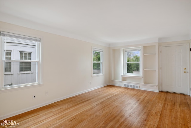 empty room with light wood-style floors and baseboards