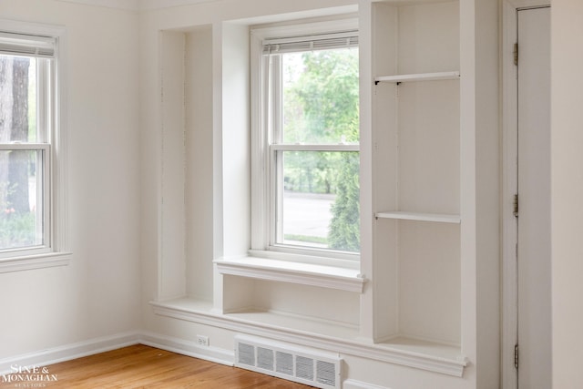 mudroom featuring light wood-style floors and baseboards